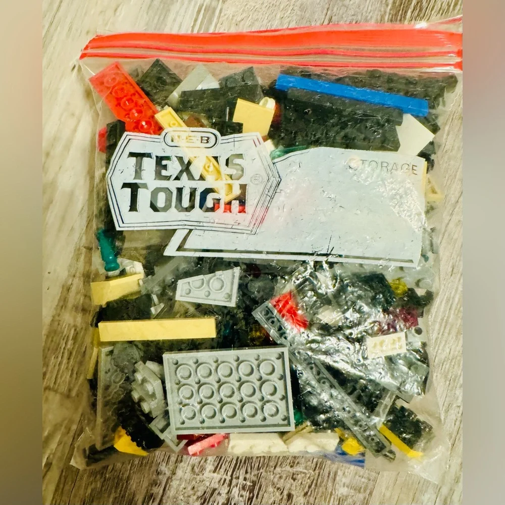 0.697 lbs. Net weight of small Lego bricks. Various parts and pieces. There are